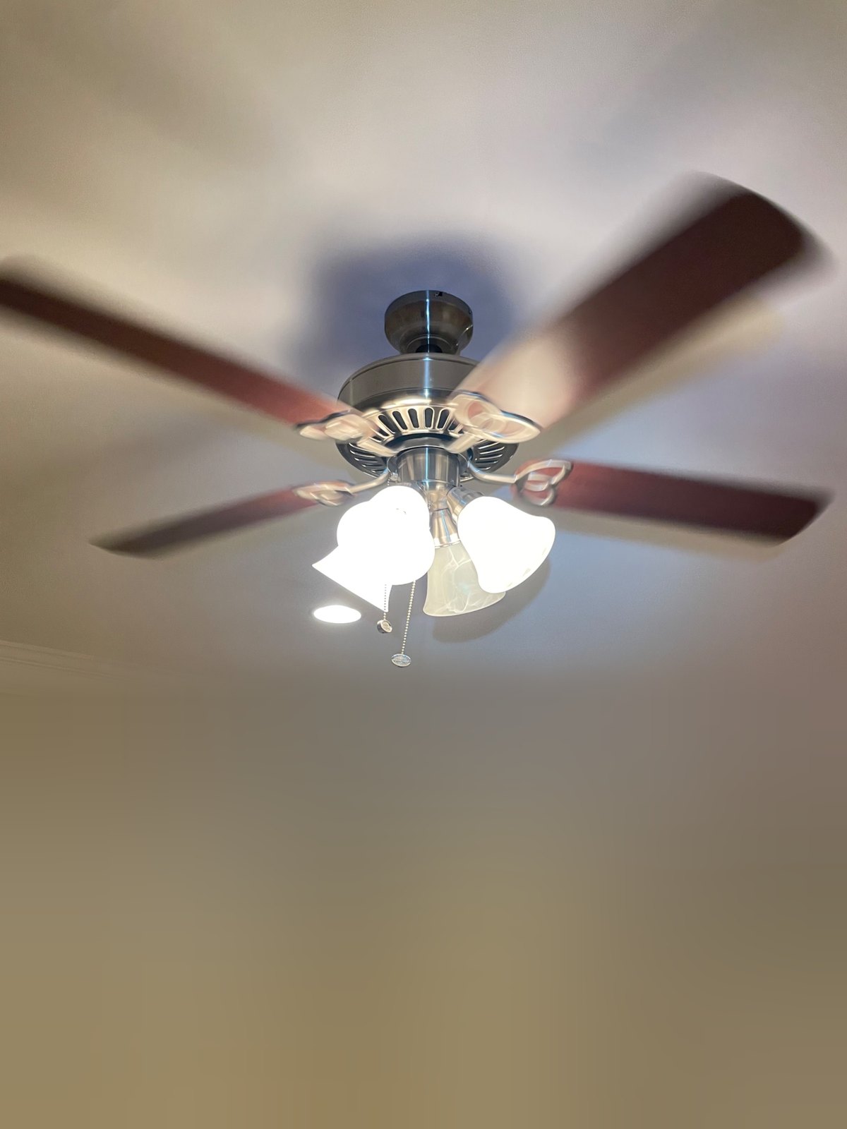 A new ceiling fan with a light kit on a high two-story ceiling